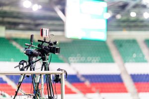 How do sports media outlets influence public perception of athletes?
